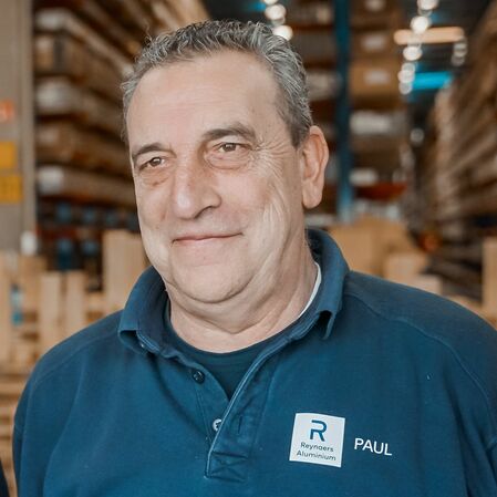 Portrait photograph of Paul De Caerle, Senior Warehouse Order Picker at Reynaers Aluminium.