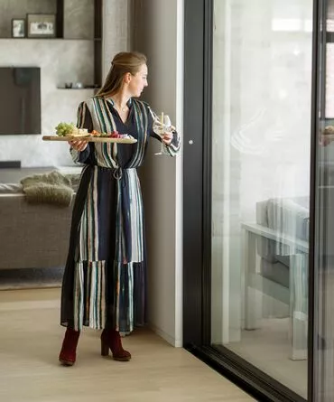 A woman opening a sliding window