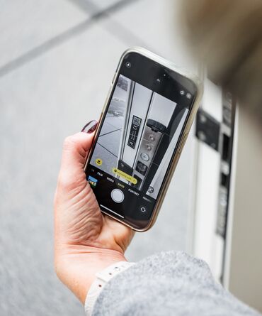 Woman taking picture of DigiTrace label on white sliding door.