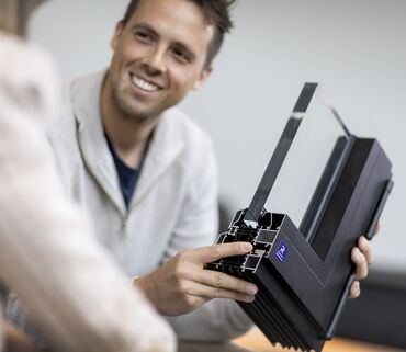 Man holding corner sample of black aluminium window