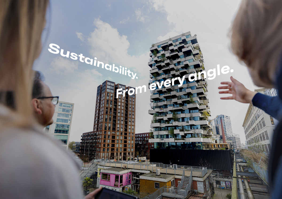 Man and woman pointing at green building in Eindhoven.