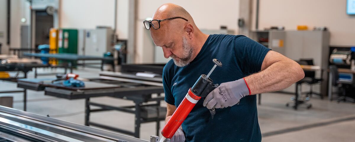 Fabricator preparing aluminium profiles in the workshop.