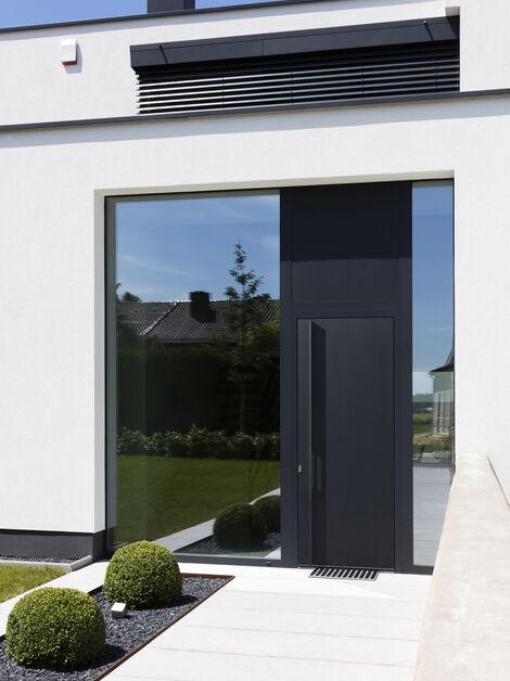 Black aluminium panel door in modern home.